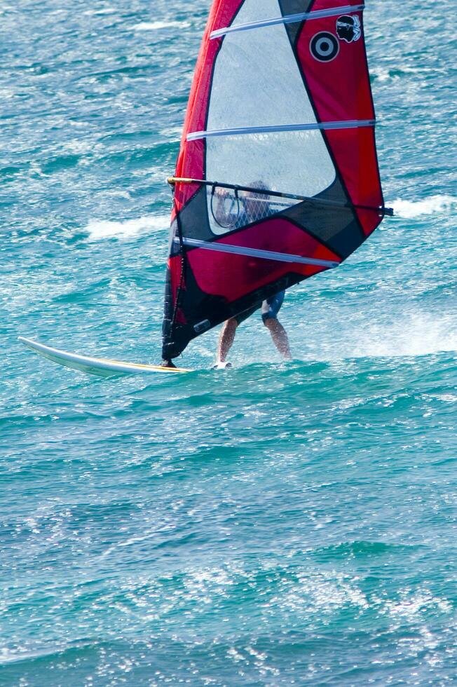 a man windsurfing in the ocean photo