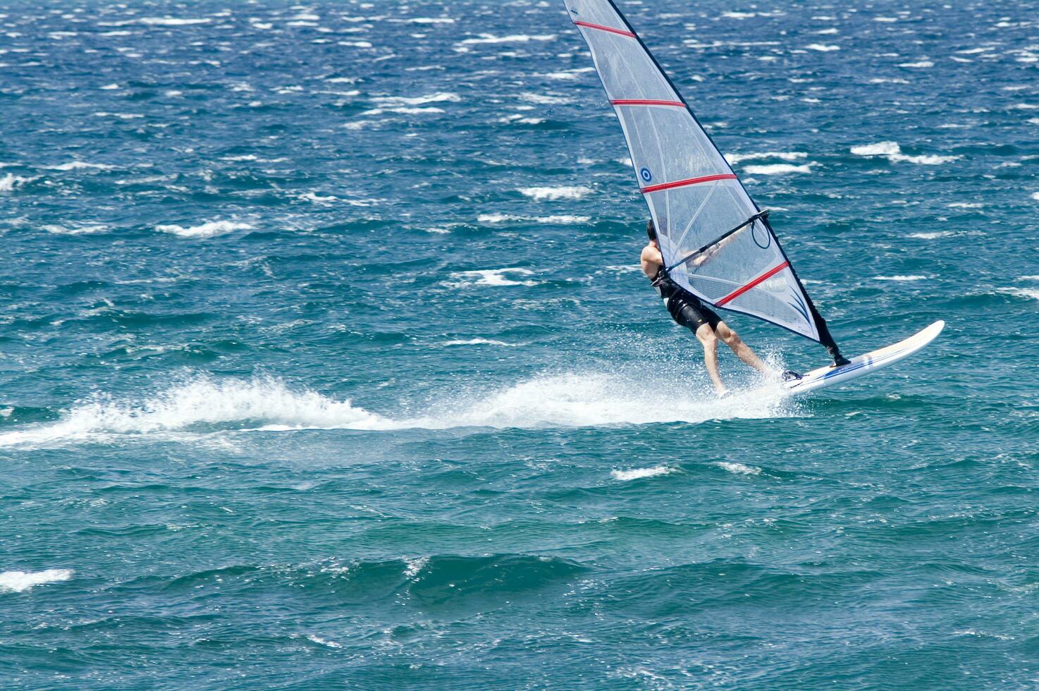 a man windsurfing in the ocean photo