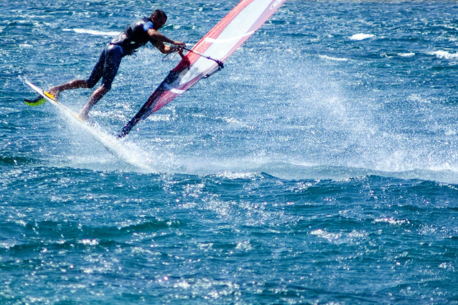 a man windsurfing in the ocean photo