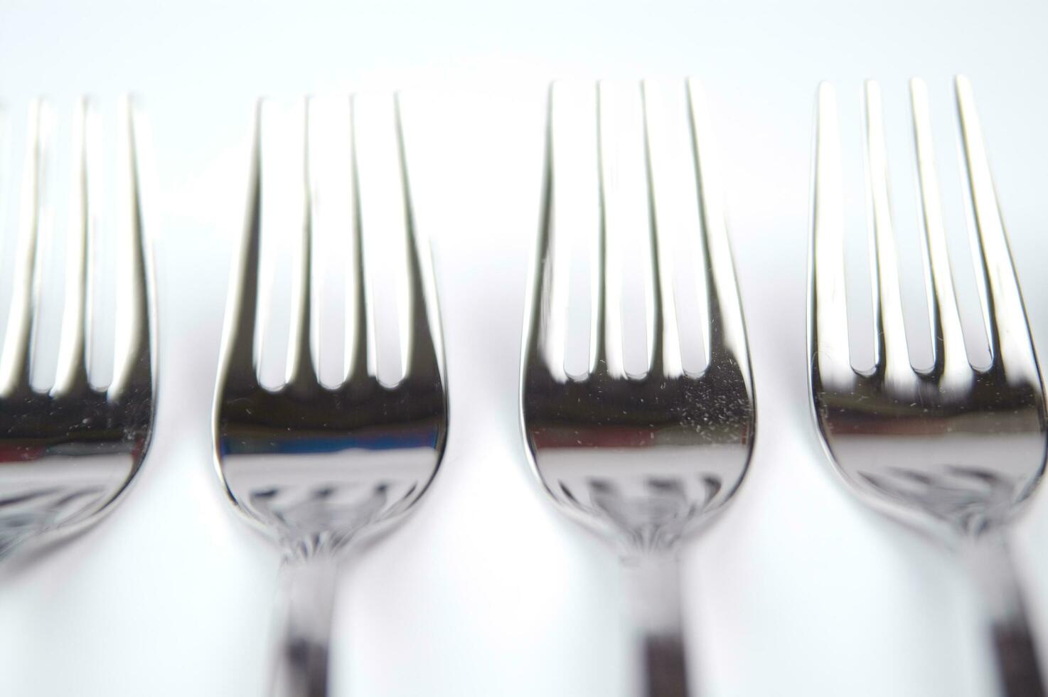 many forks and knives are arranged in a pile photo