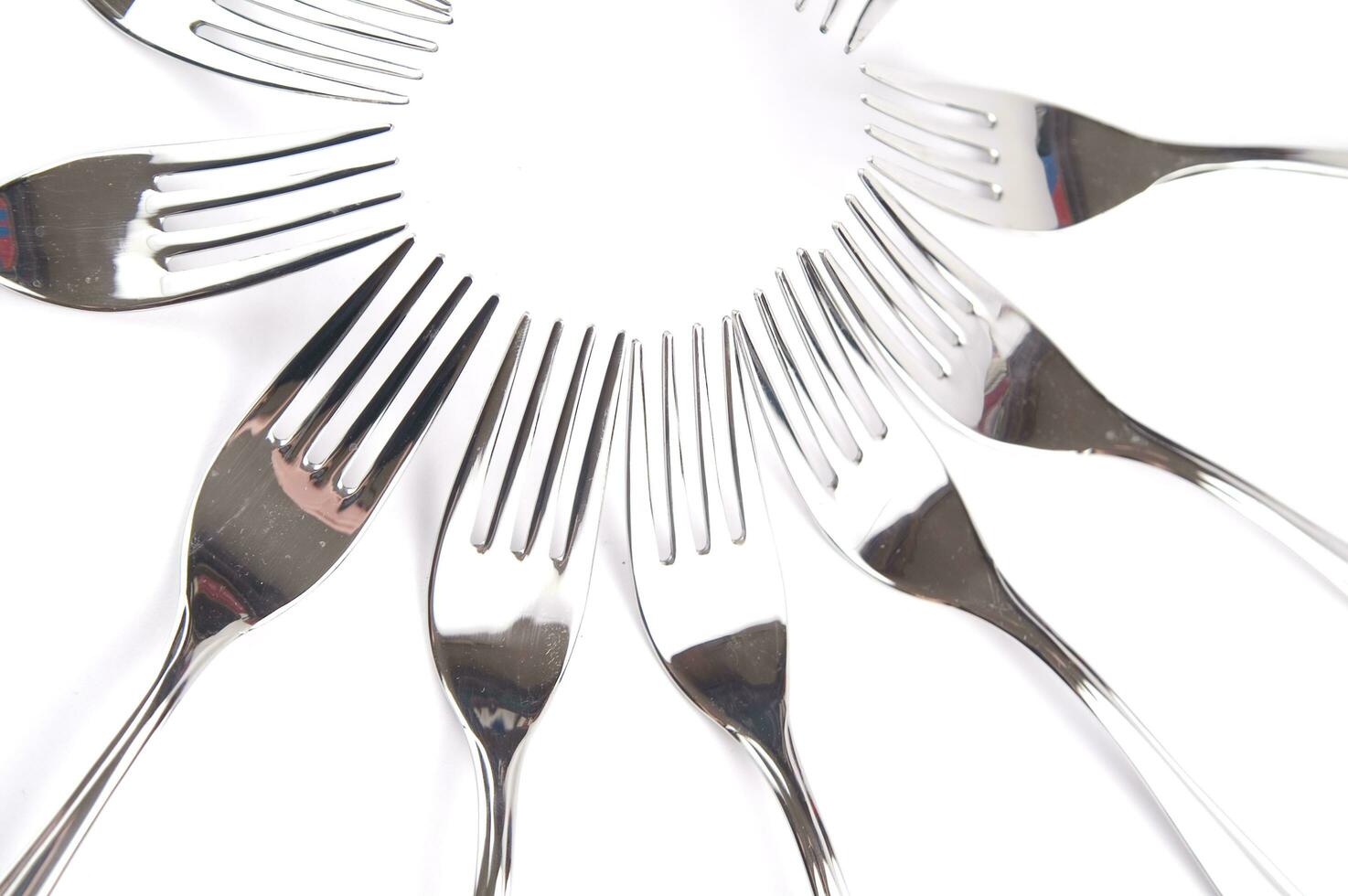 many forks and knives are arranged in a pile photo
