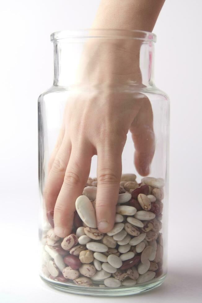 a jar of beans and a glass jar with beans photo