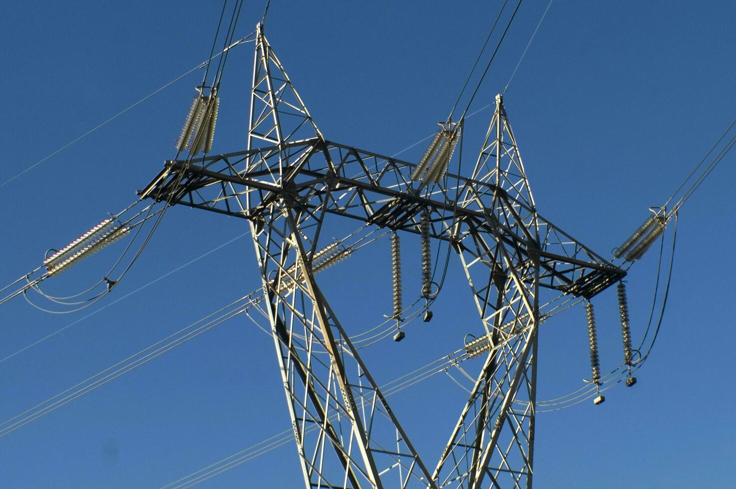 a large electrical tower with wires and wires photo