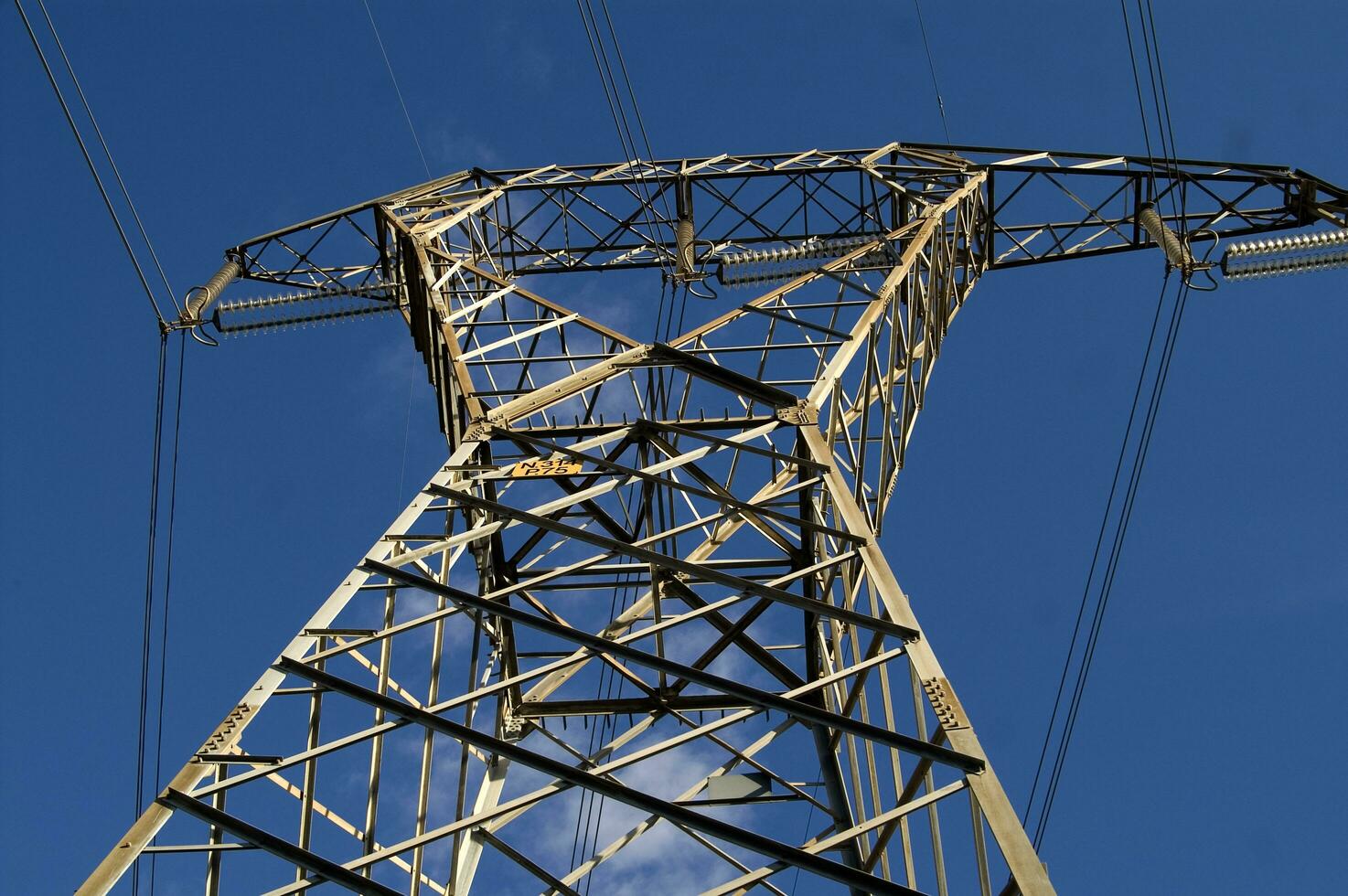 a large electrical tower with wires and wires photo