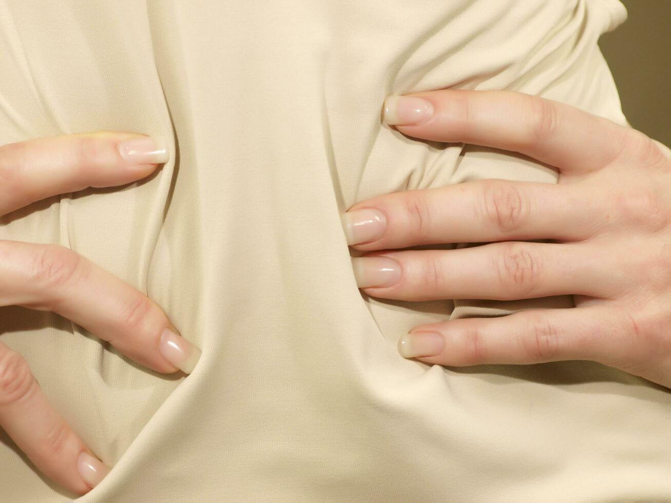 a woman is holding her stomach photo