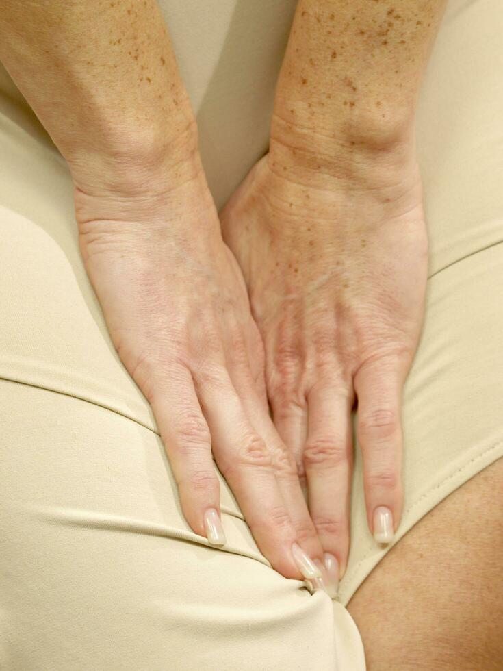 a woman is holding her stomach photo
