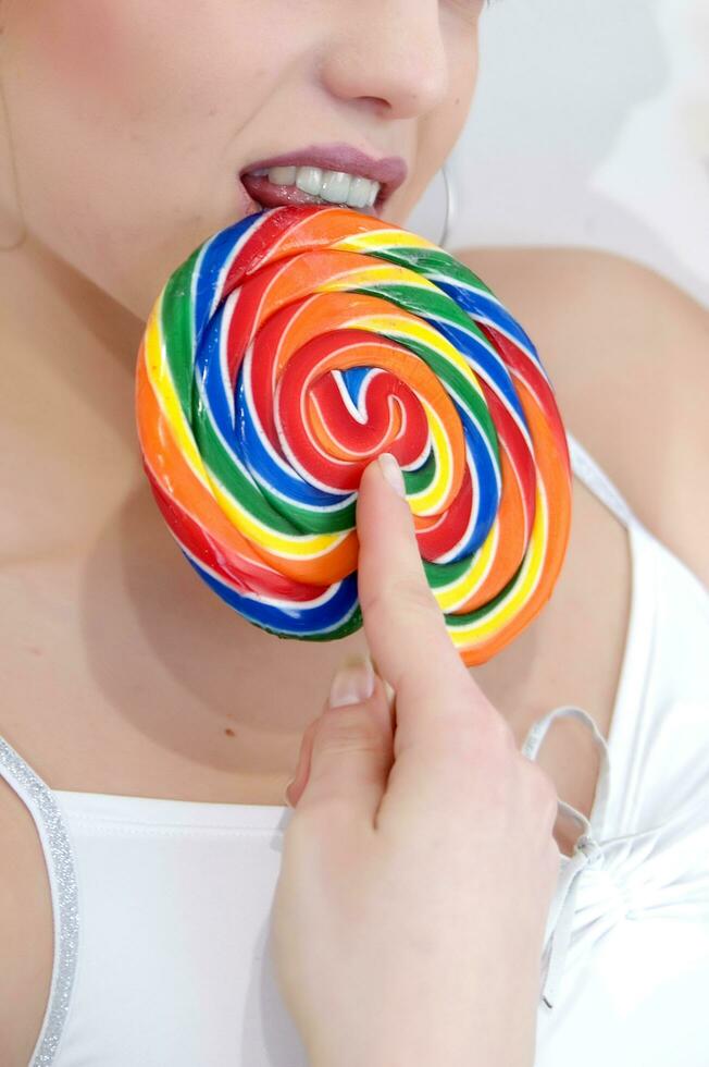 a woman holding a large lollipop photo