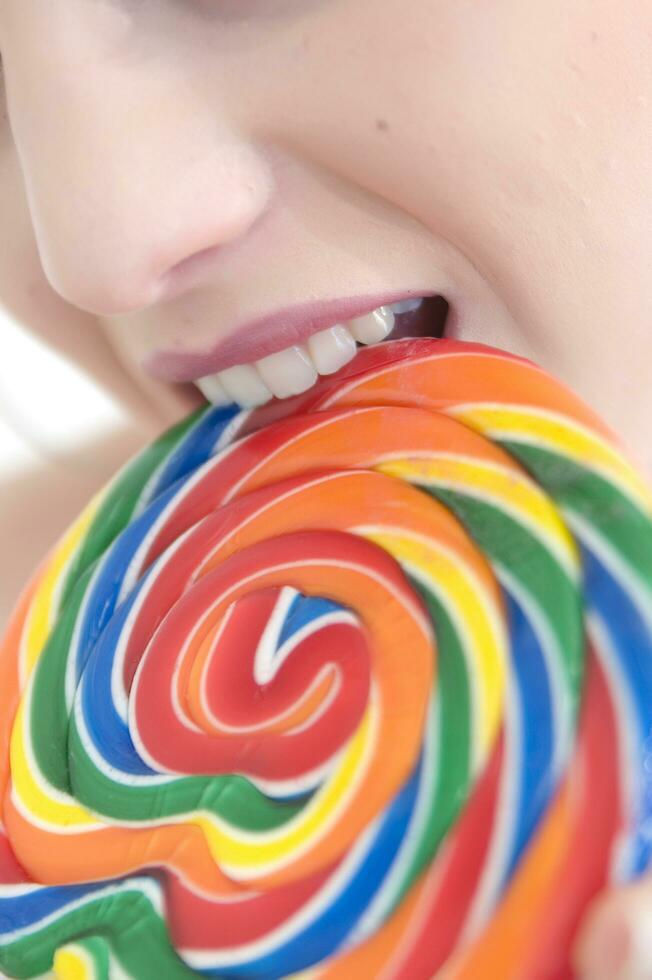 a woman holding a large lollipop photo