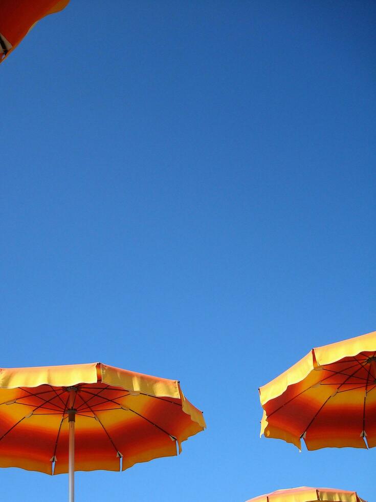 a row of orange and yellow umbrellas photo