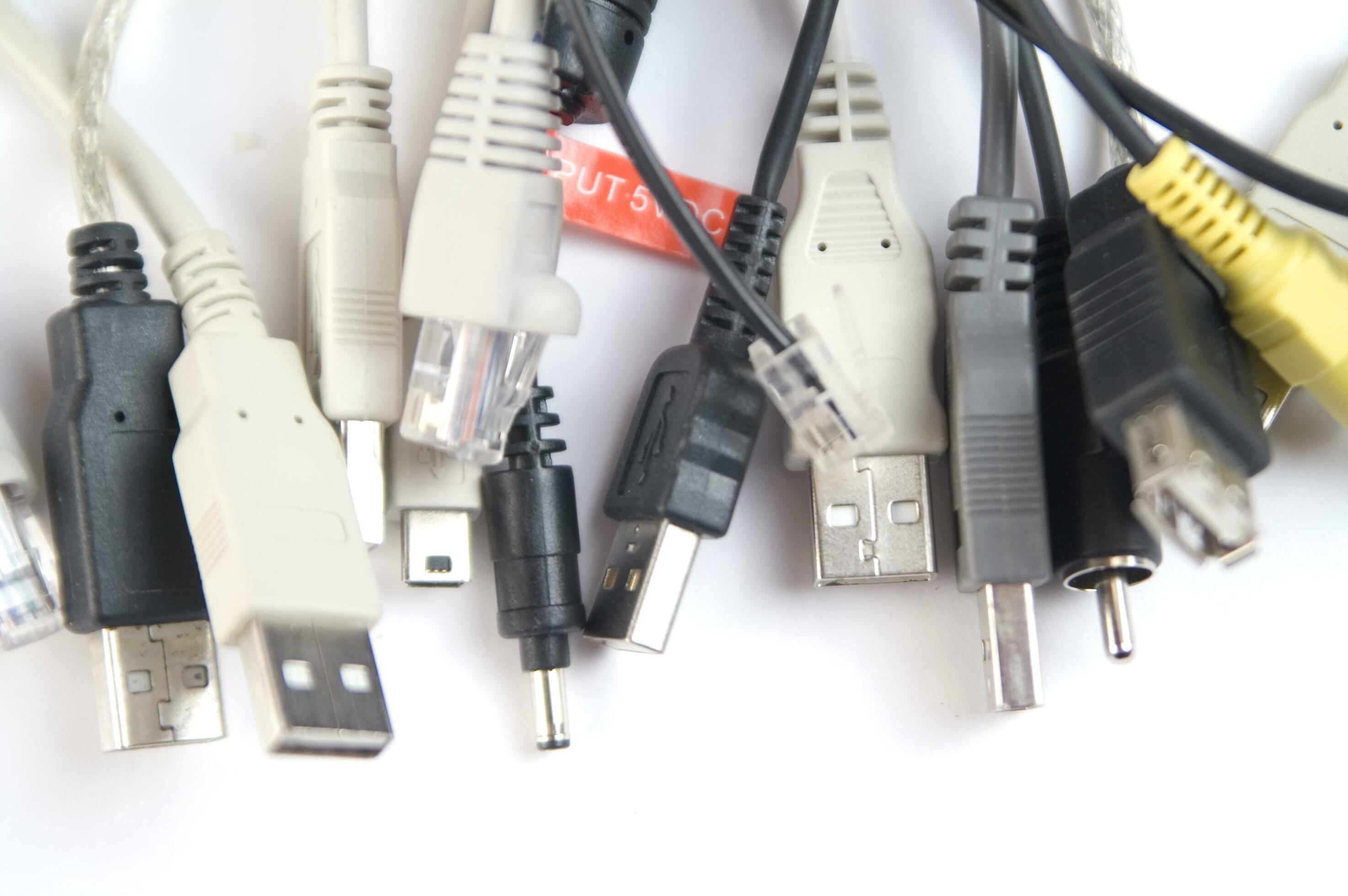 a hand holding several different types of cables 27094462 Stock Photo