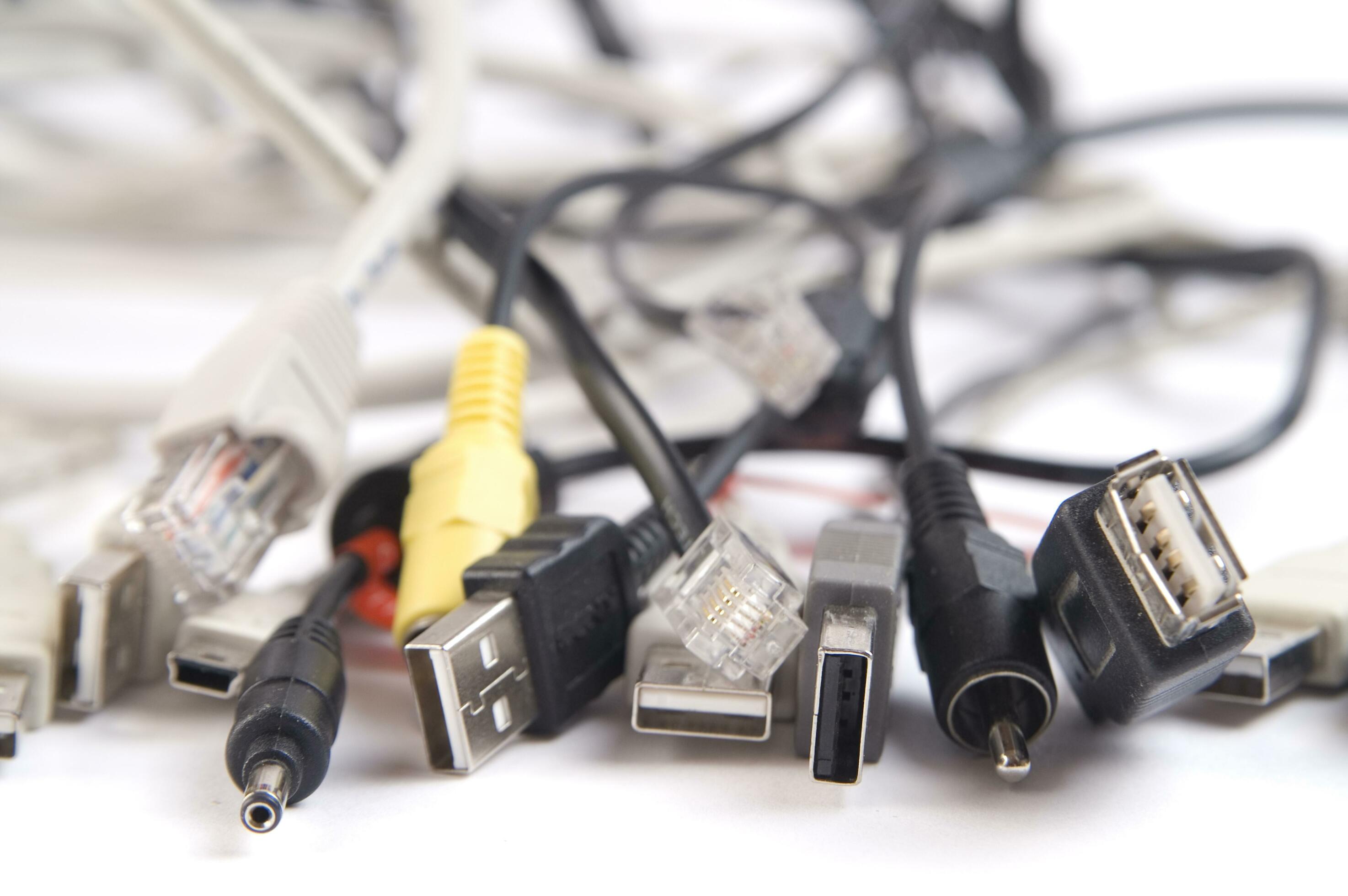 a hand holding several different types of cables 27094471 Stock Photo