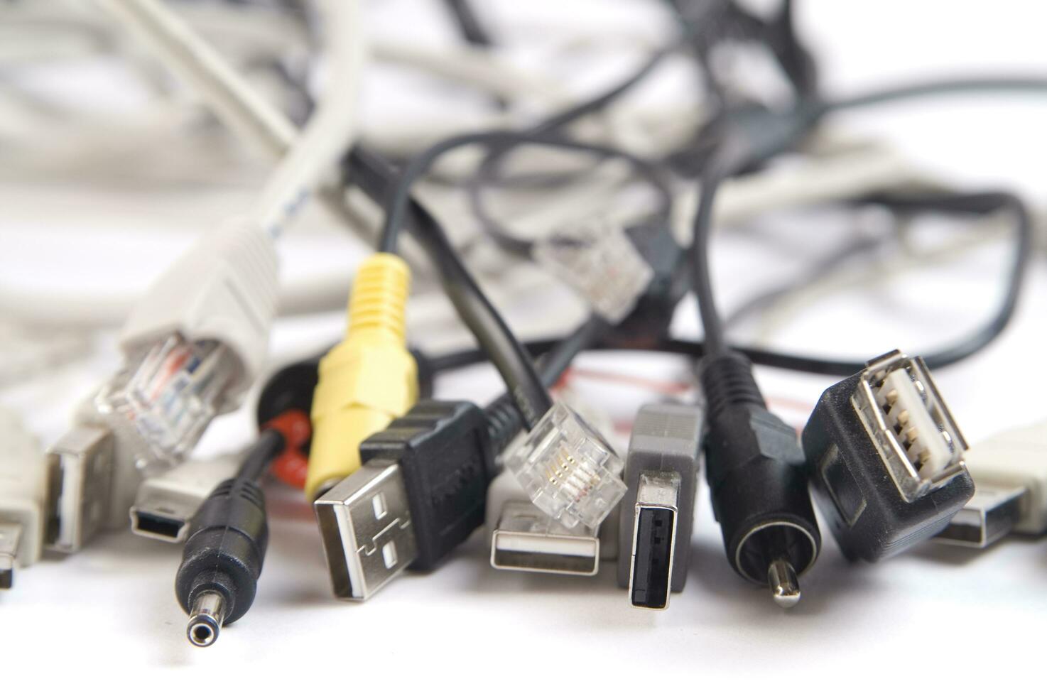 a hand holding several different types of cables photo