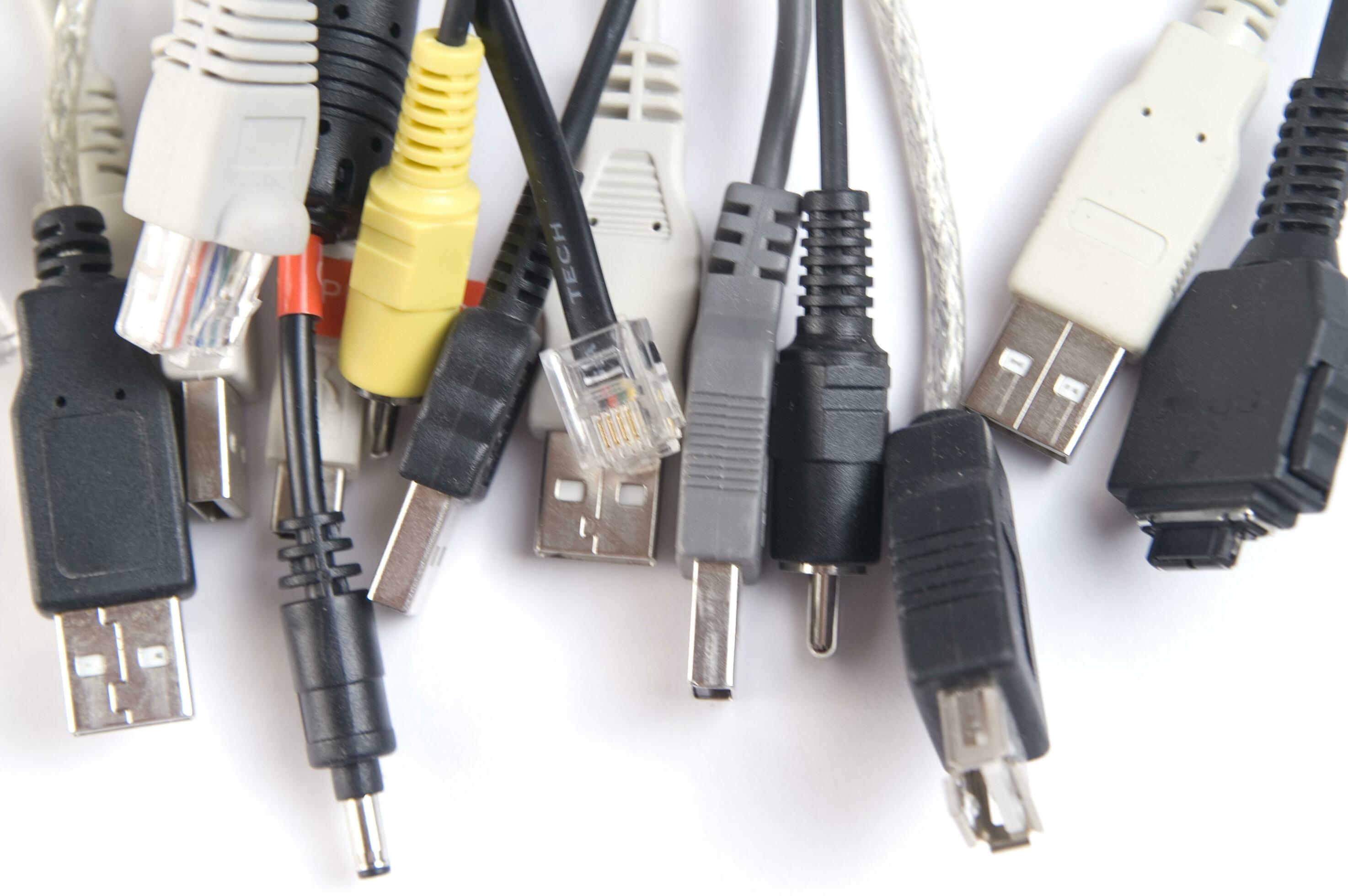 a hand holding several different types of cables 27094472 Stock Photo