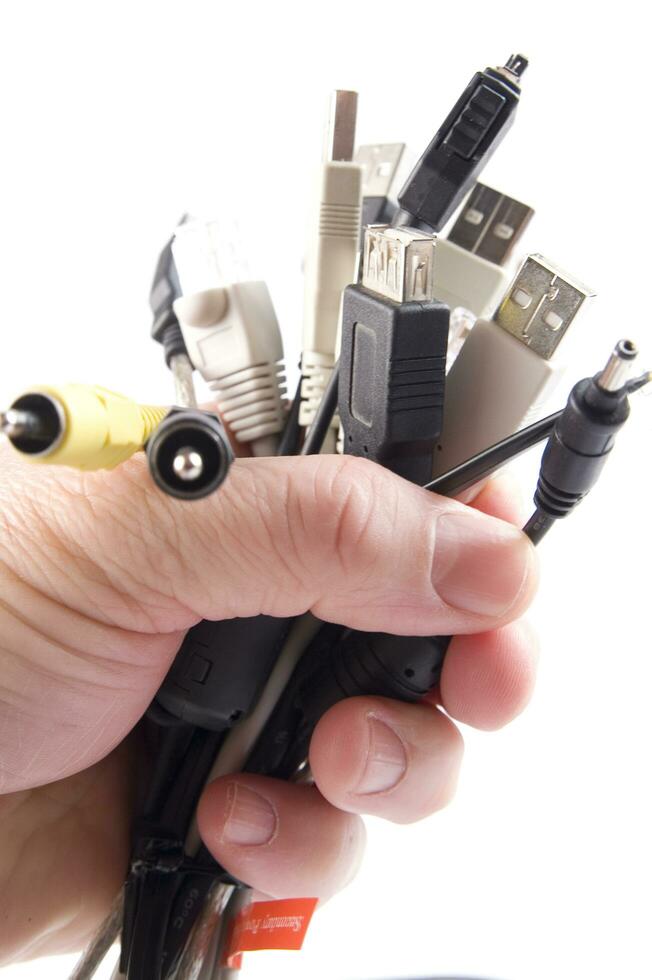 a hand holding several different types of cables photo