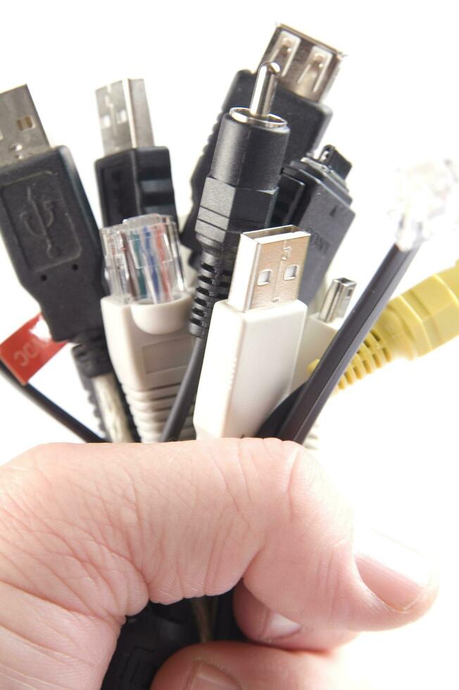 a hand holding several different types of cables photo