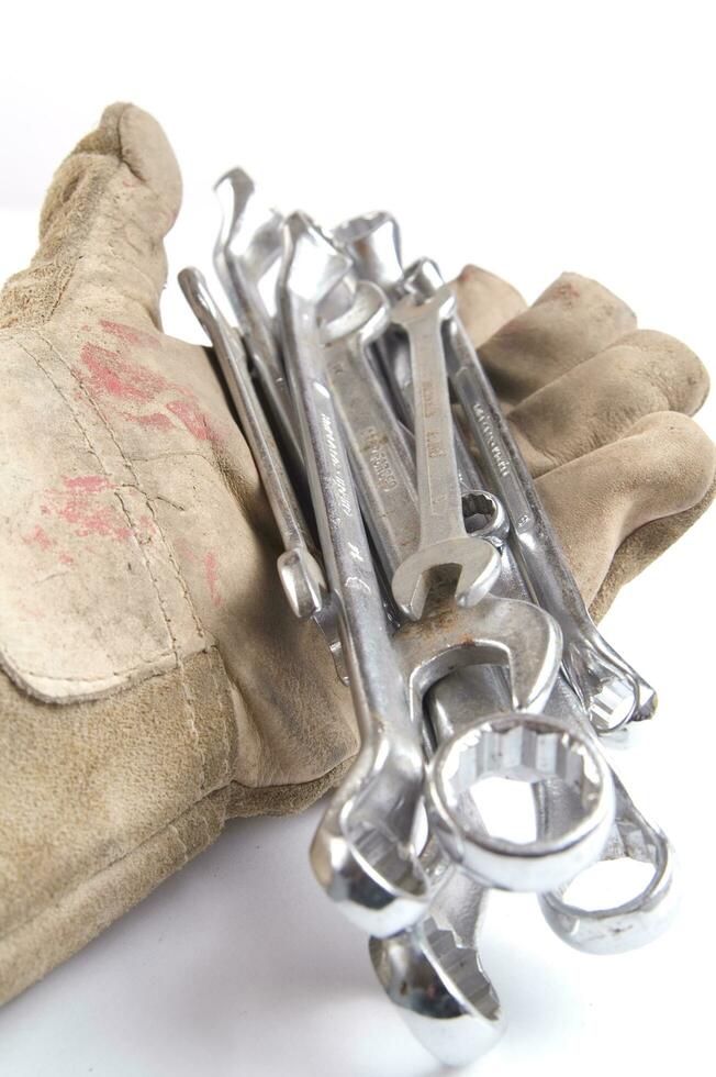 a pair of gloves with a wrench and a pair of pliers photo