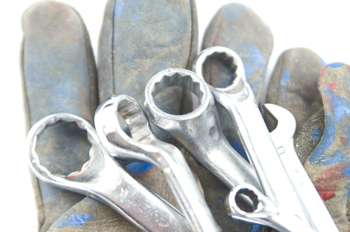 a pair of gloves with a wrench and a pair of pliers photo