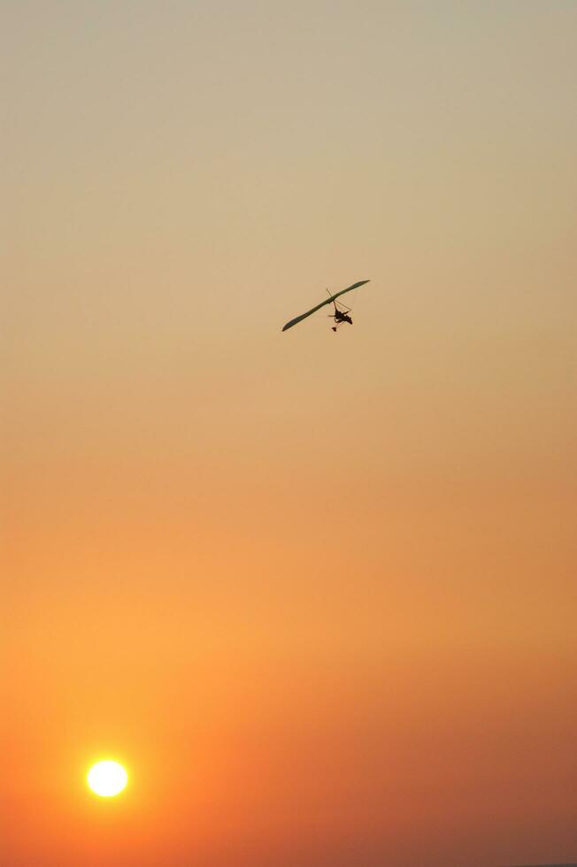 a hang glider is flying in the air photo