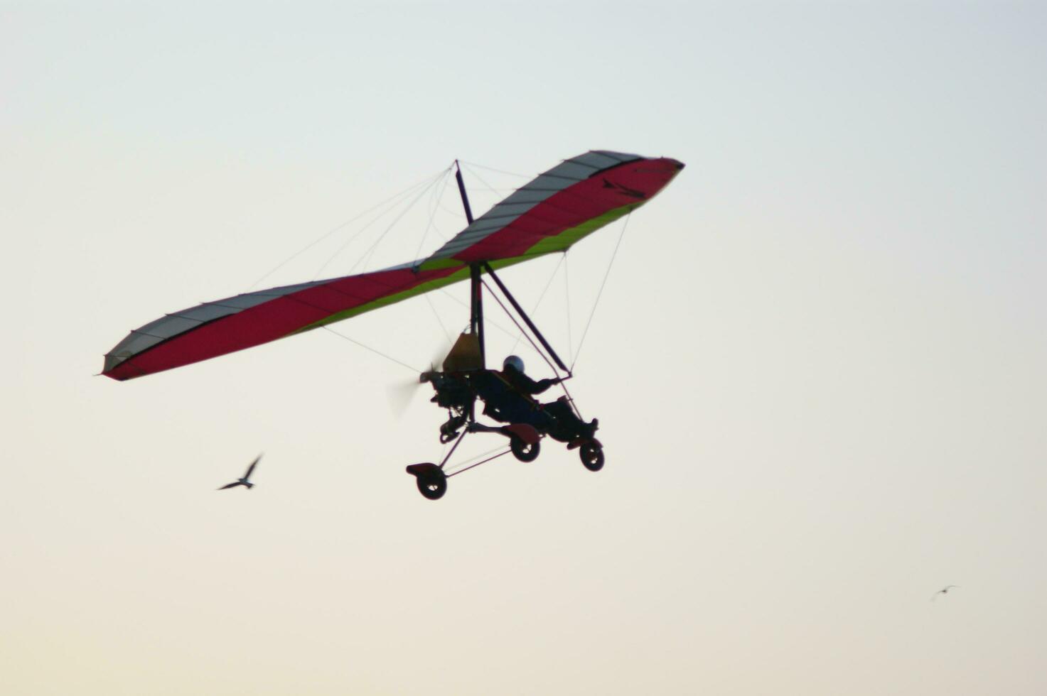 a hang glider is flying in the air photo