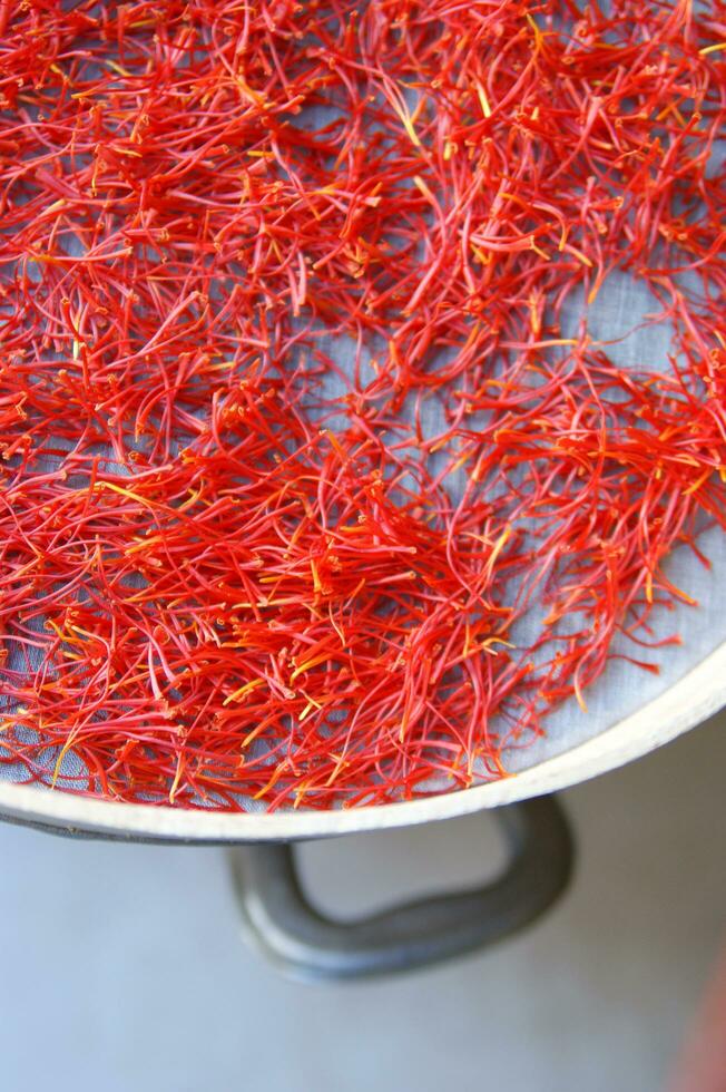 a pile of red saffron on a plate photo