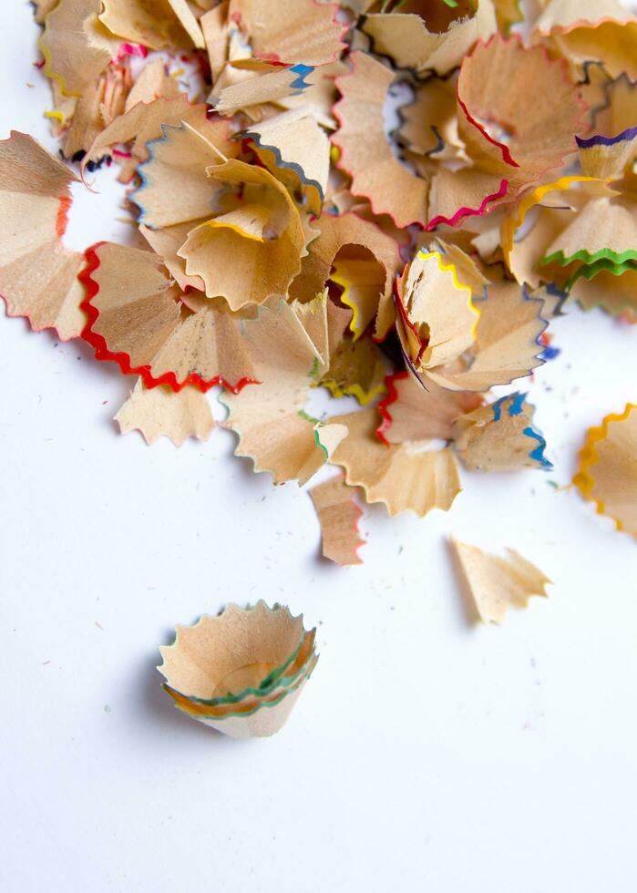 a pile of colored pencils on a white surface photo