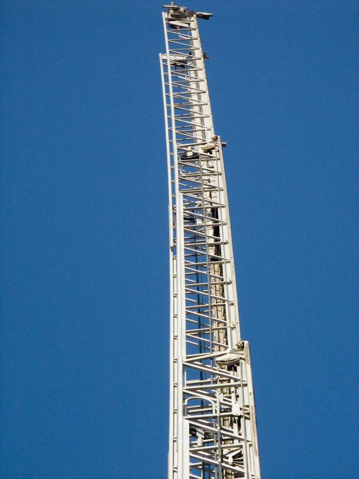 a tall metal tower with a blue sky in the background photo