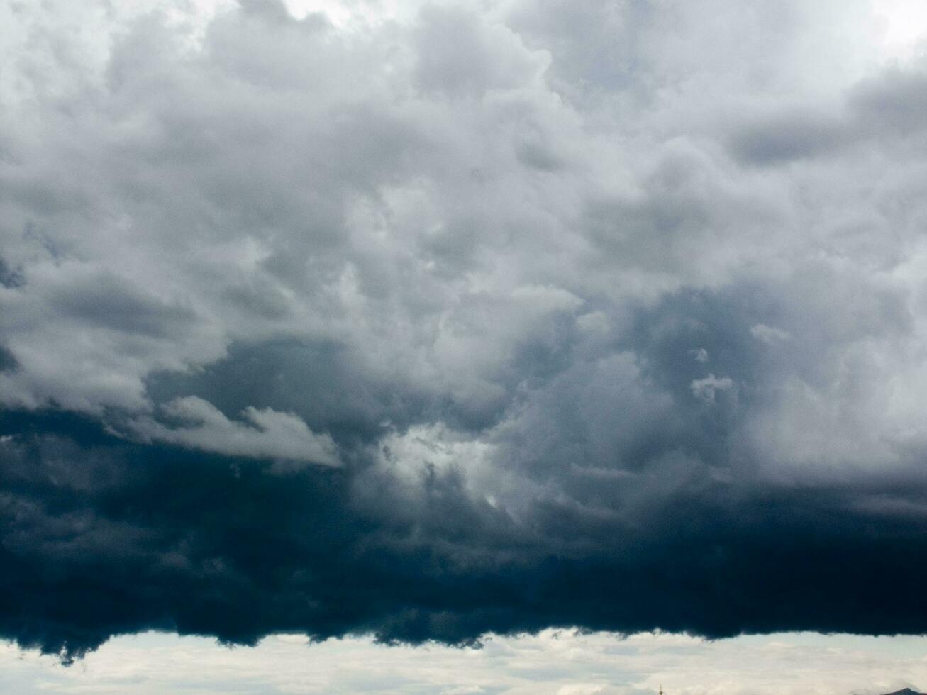 a large dark cloud is seen over a body of water photo