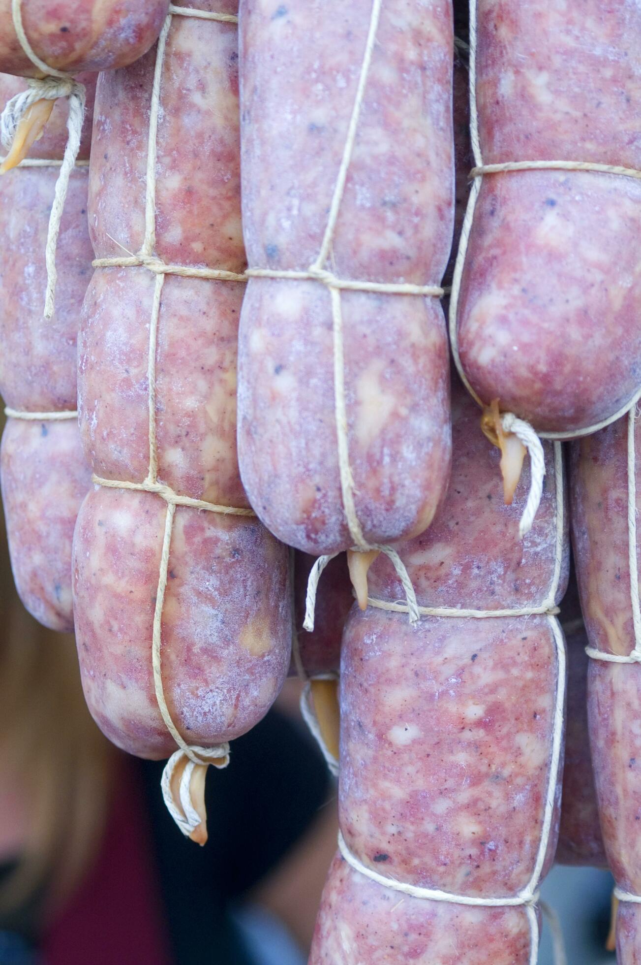a pile of sausages wrapped in rope 27095421 Stock Photo at Vecteezy