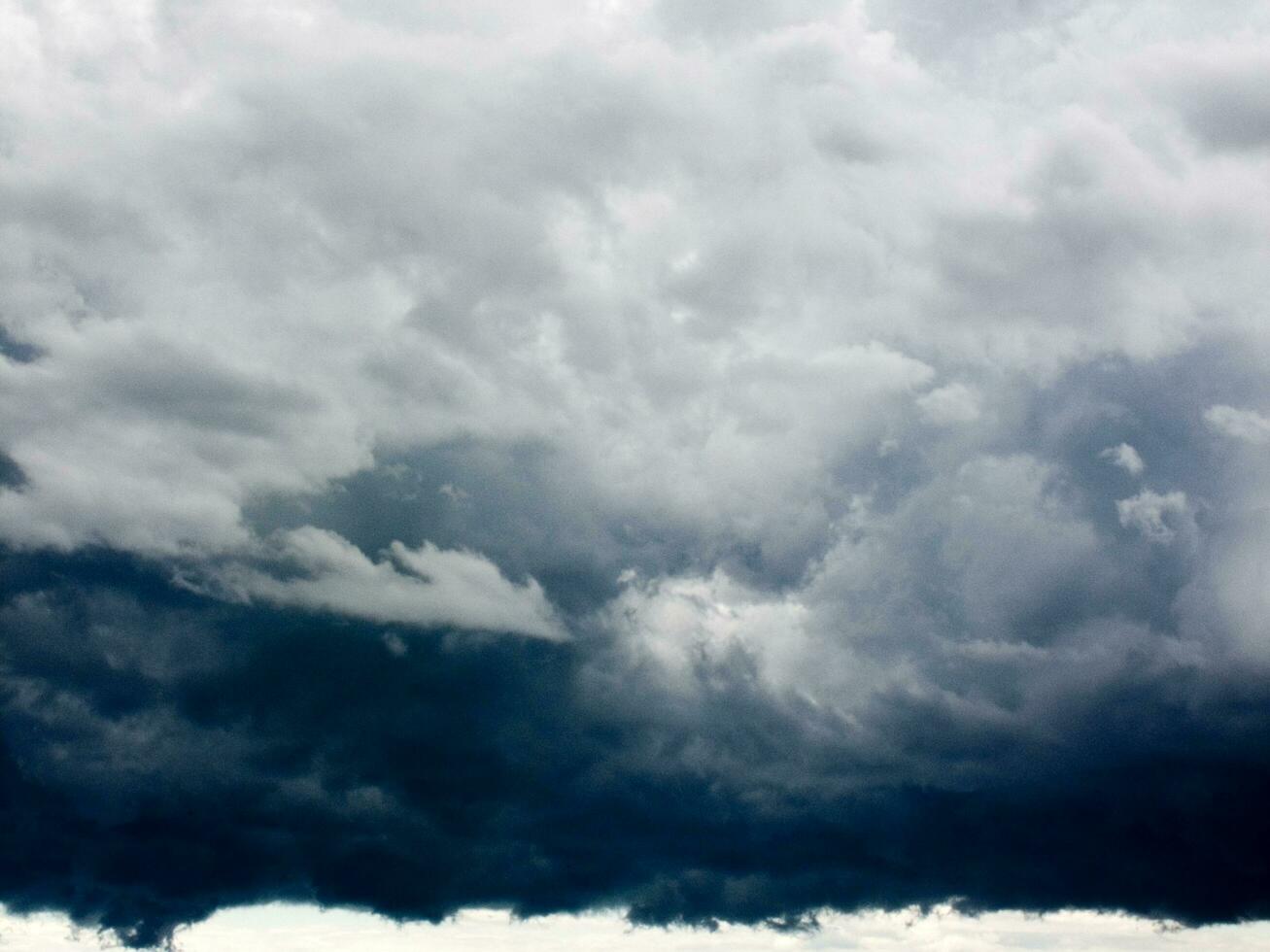 a large dark cloud is seen over a body of water photo