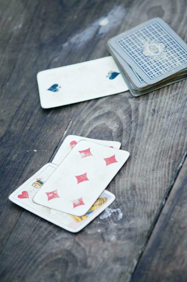 a person is playing cards with a deck of cards photo