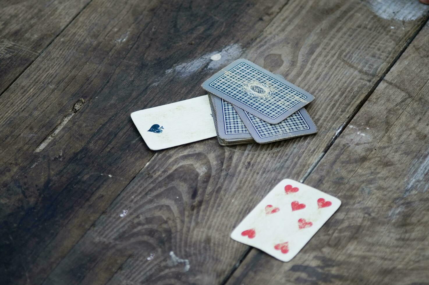 a person is playing cards with a deck of cards photo