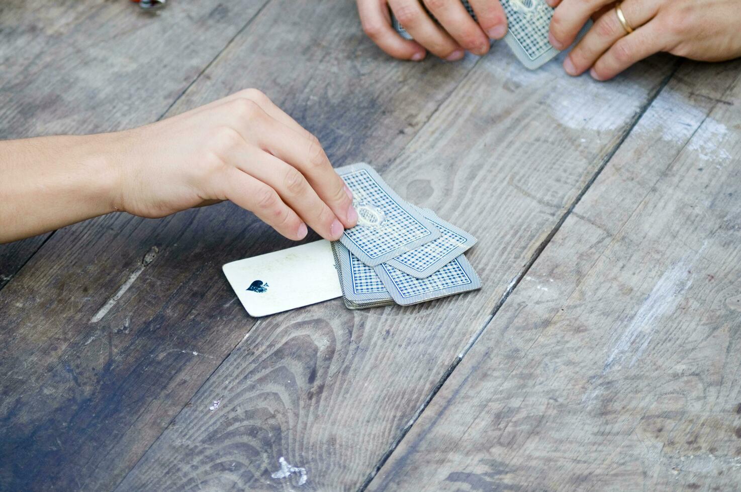 a person is playing cards with a deck of cards photo