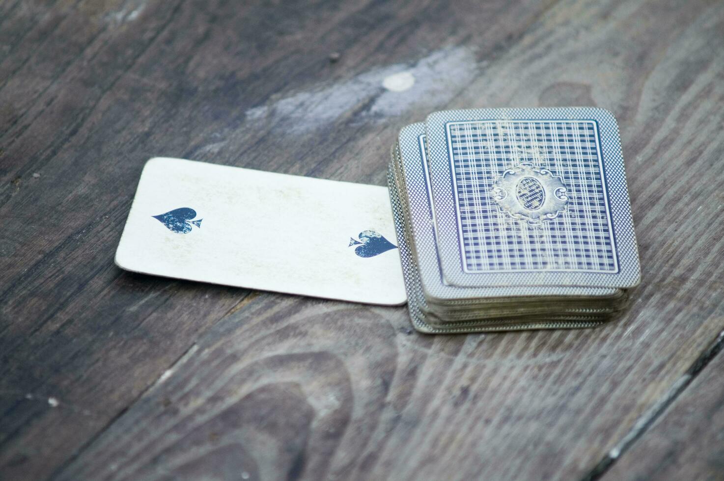 a person is playing cards with a deck of cards photo