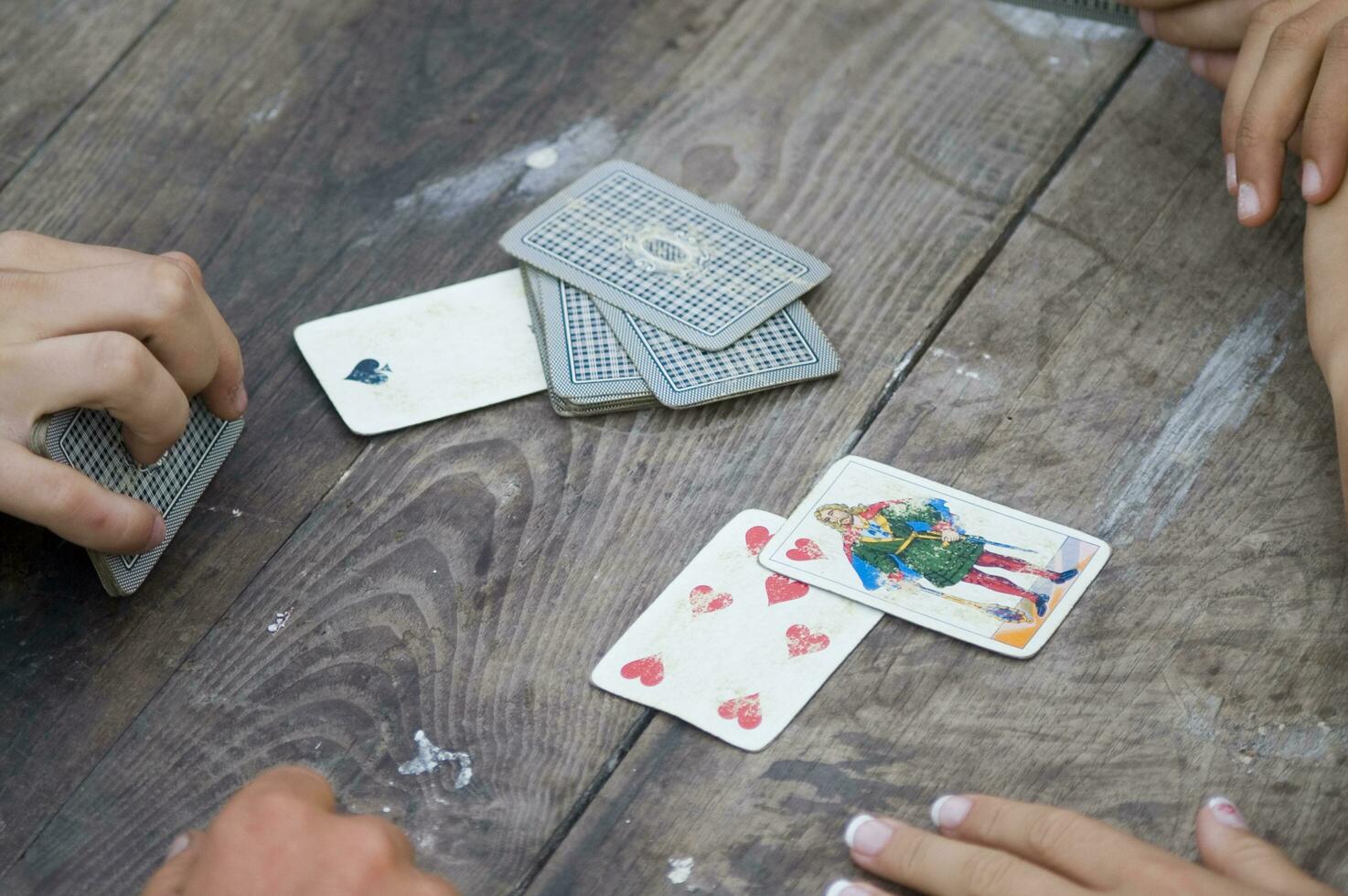 a person is playing cards with a deck of cards photo