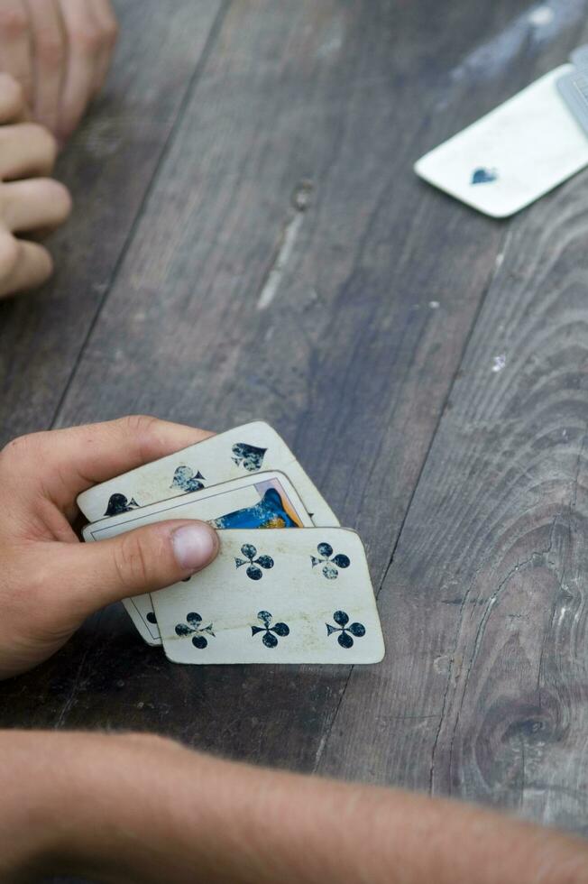 a person is playing cards with a deck of cards photo