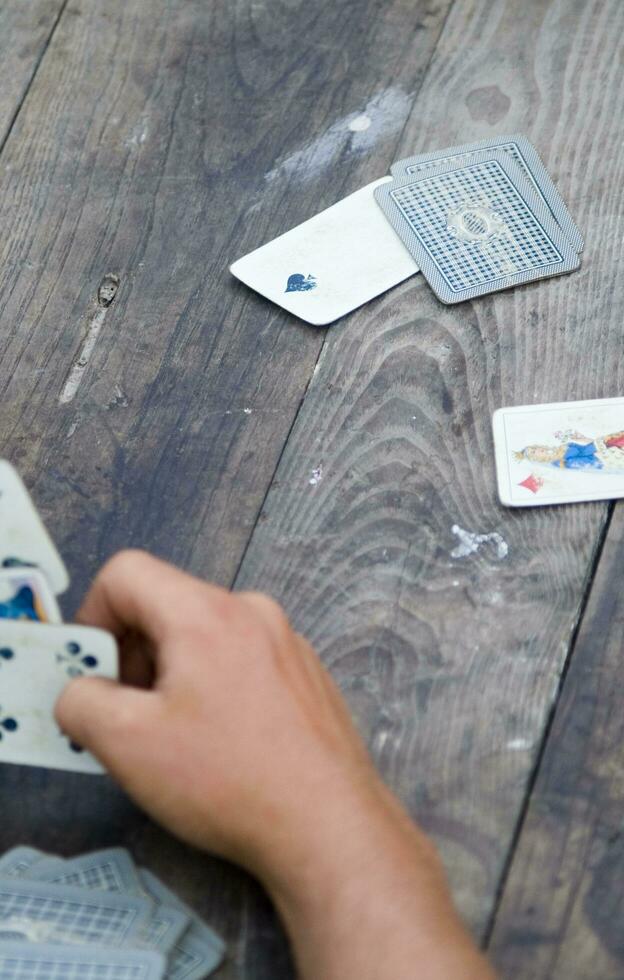 a person is playing cards with a deck of cards photo