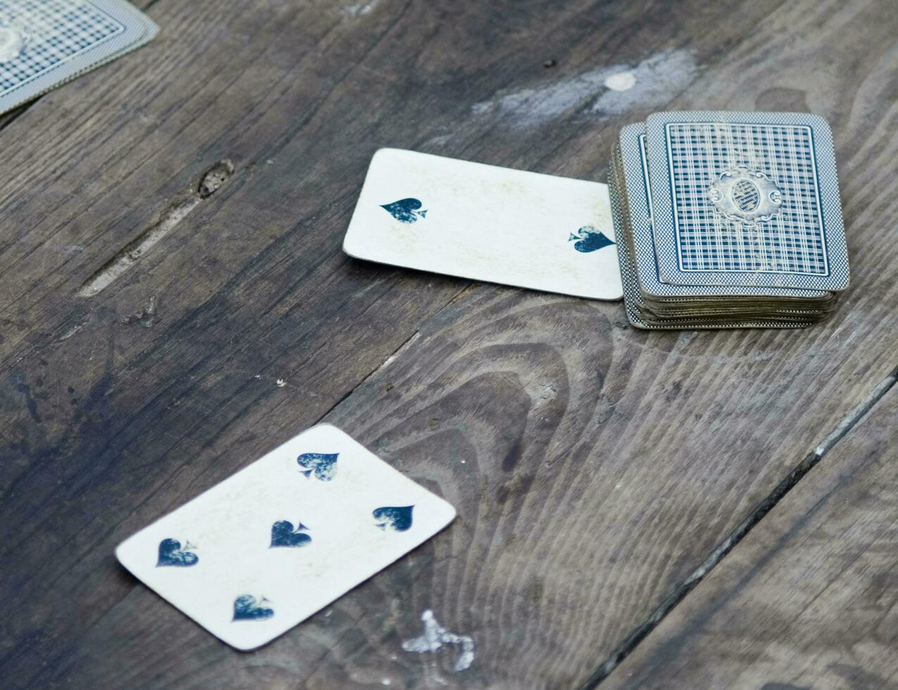 a person is playing cards with a deck of cards photo