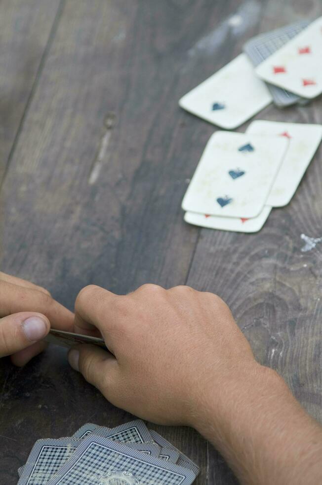 a person is playing cards with a deck of cards photo