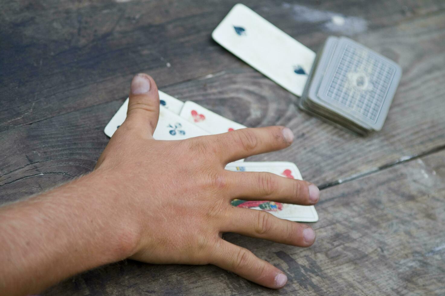 a person is playing cards with a deck of cards photo