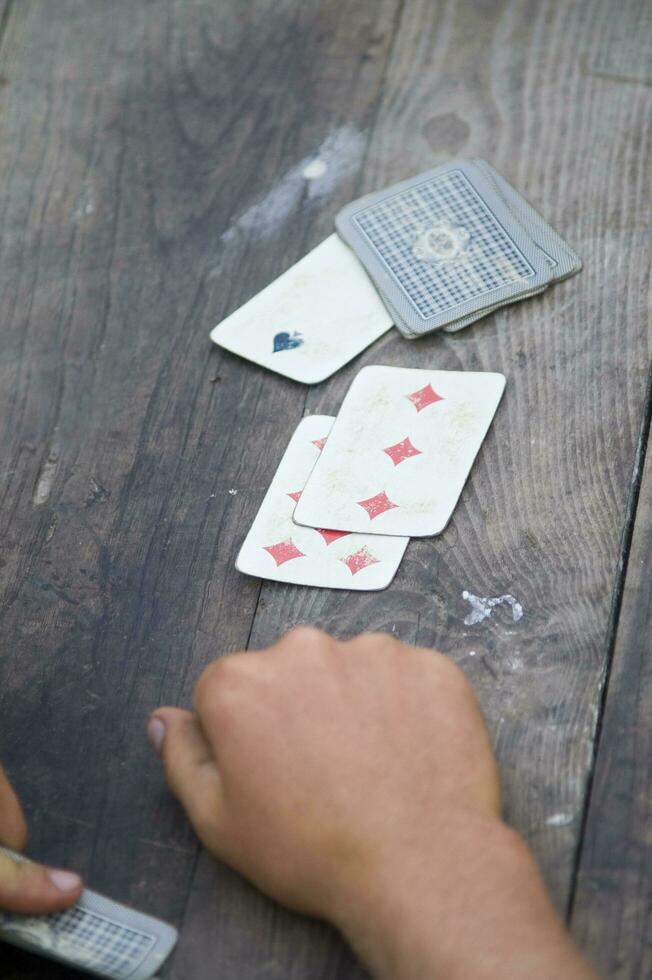 un persona es jugando tarjetas con un cubierta de tarjetas foto