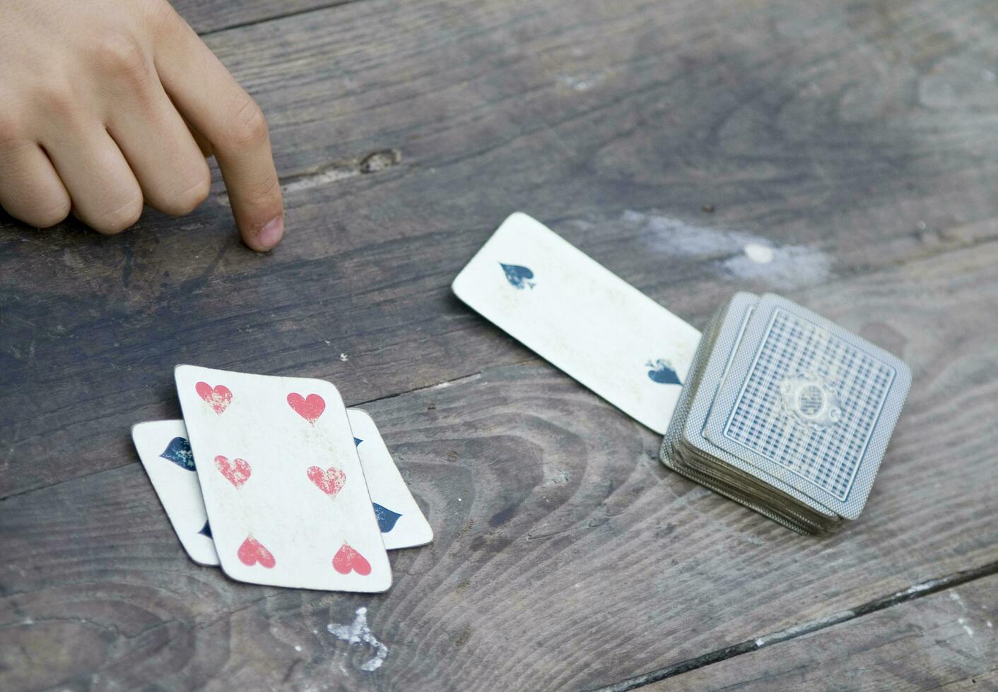 a person is playing cards with a deck of cards photo