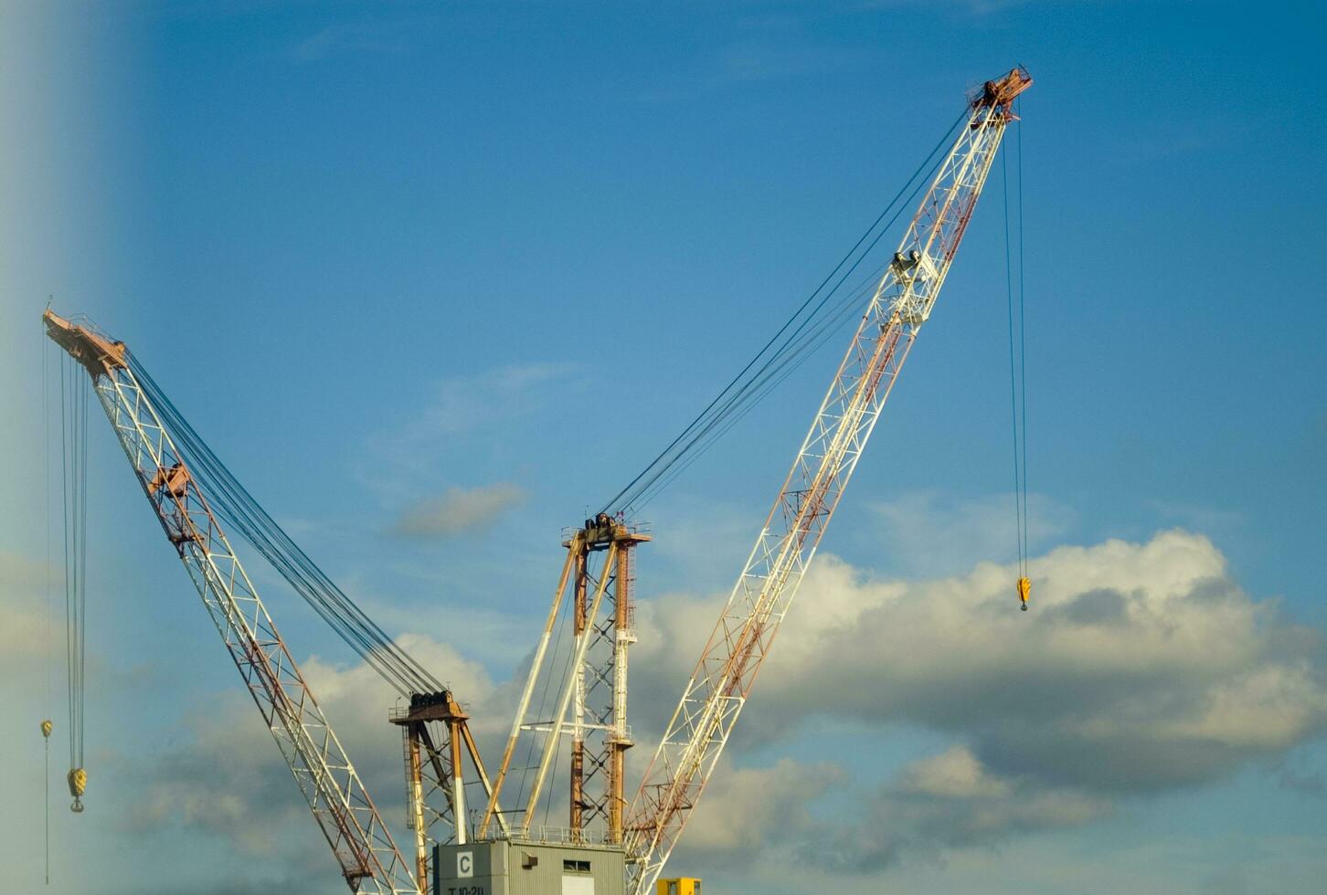 three cranes are standing in front of a blue sky photo