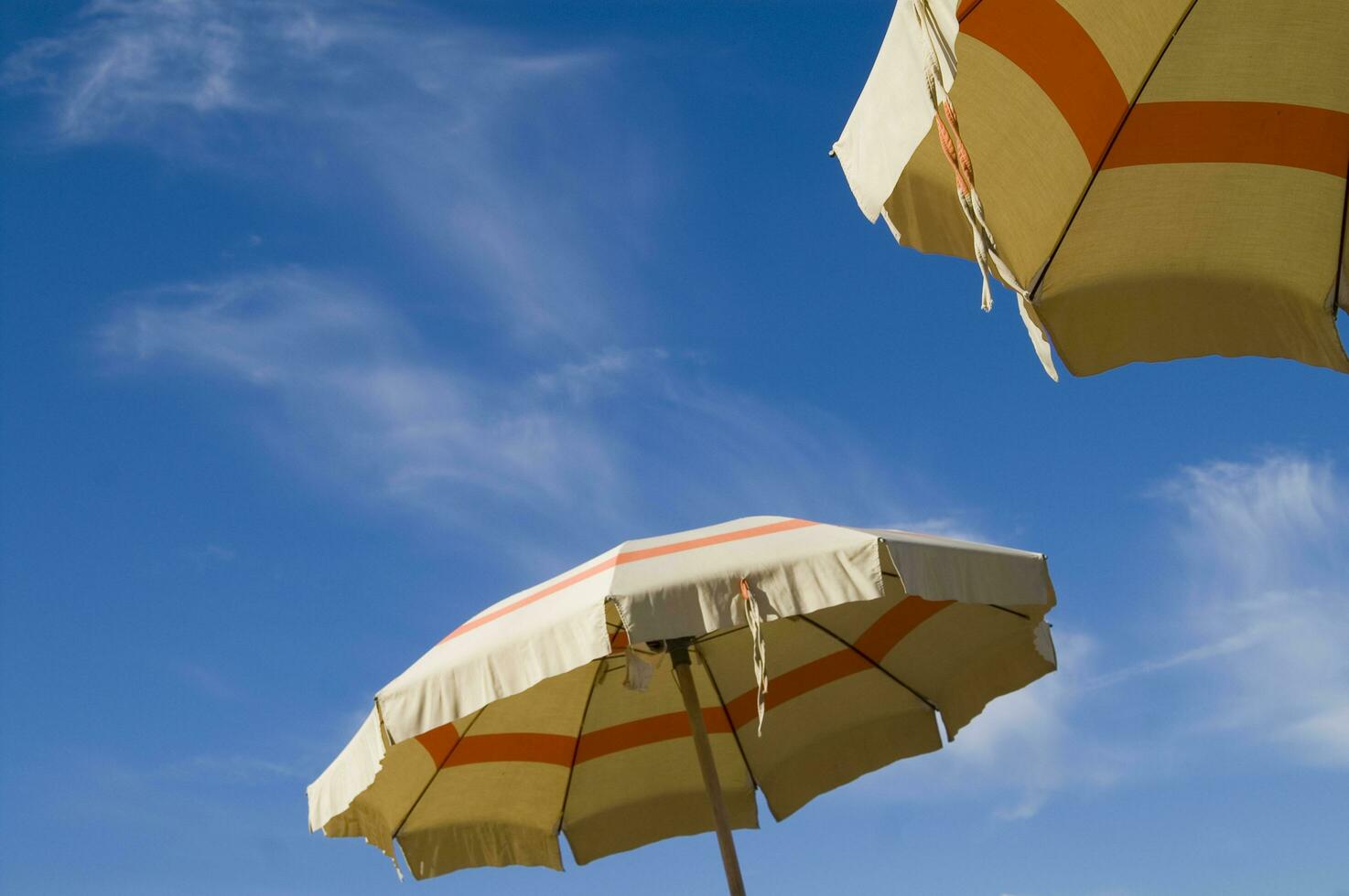 a beach umbrella with a striped cover photo