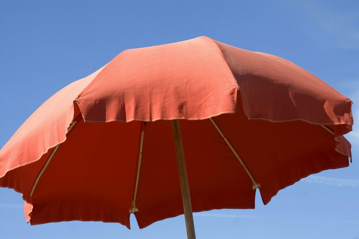 a beach umbrella with a striped cover photo