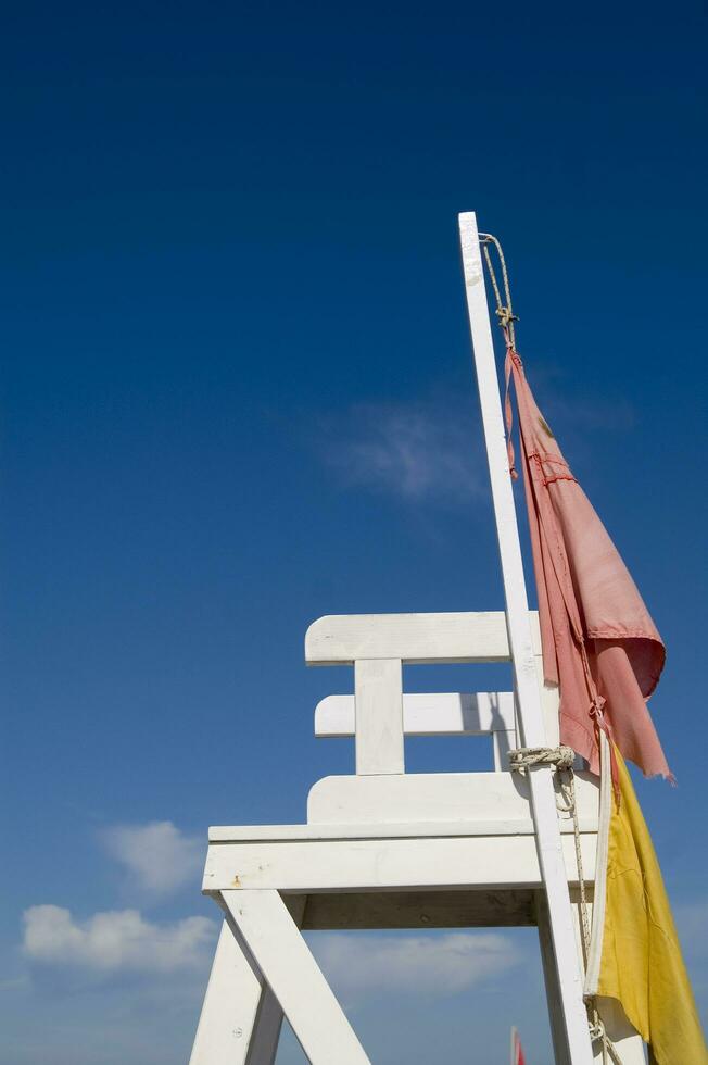 a lifeguard chair sitting on a beach photo