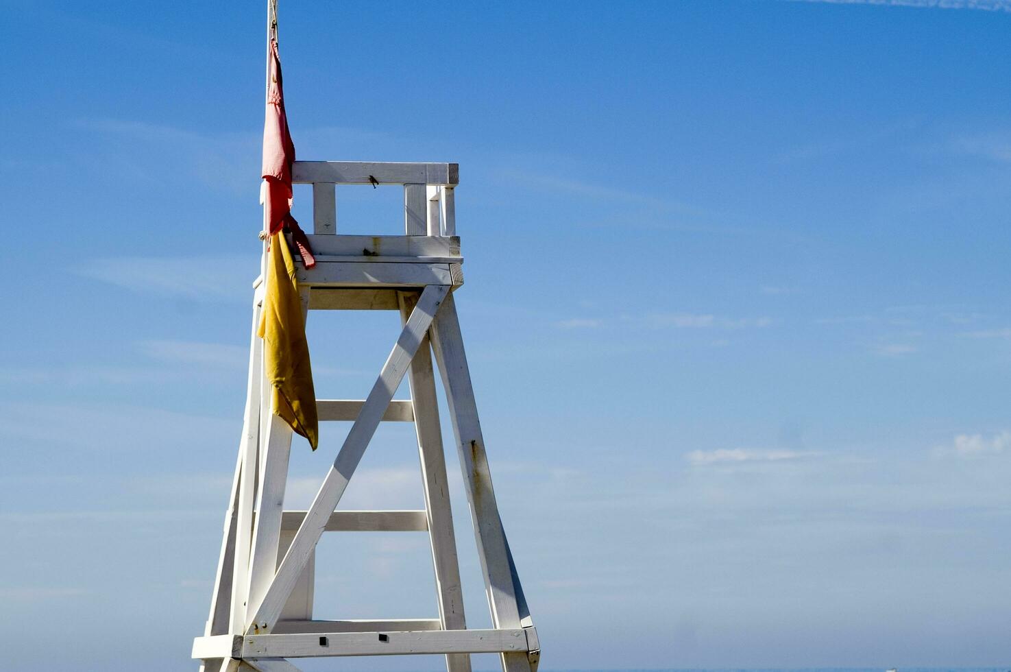a lifeguard chair sitting on a beach photo