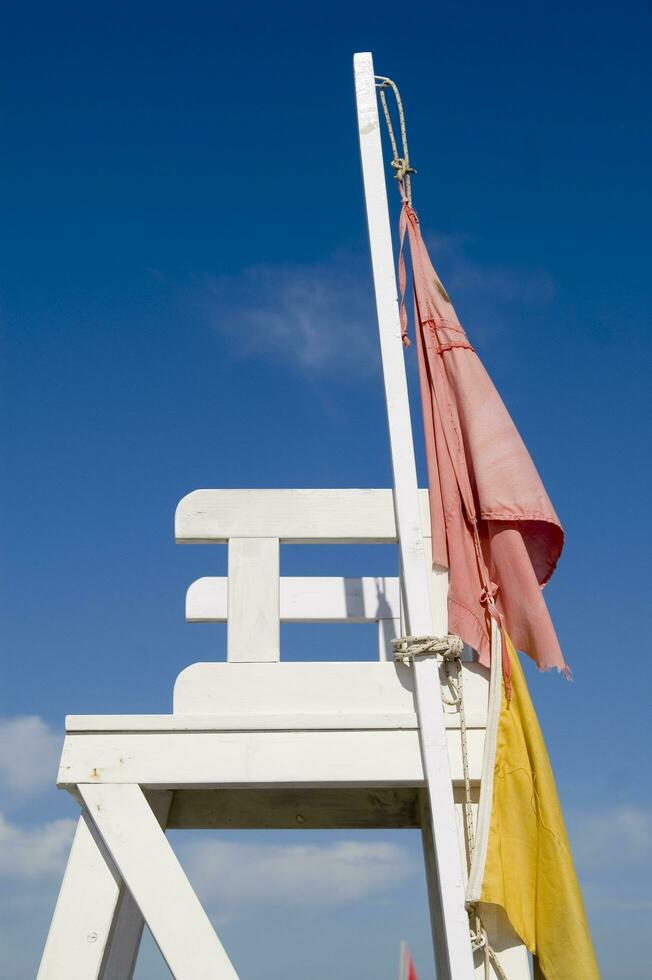 a lifeguard chair sitting on a beach photo