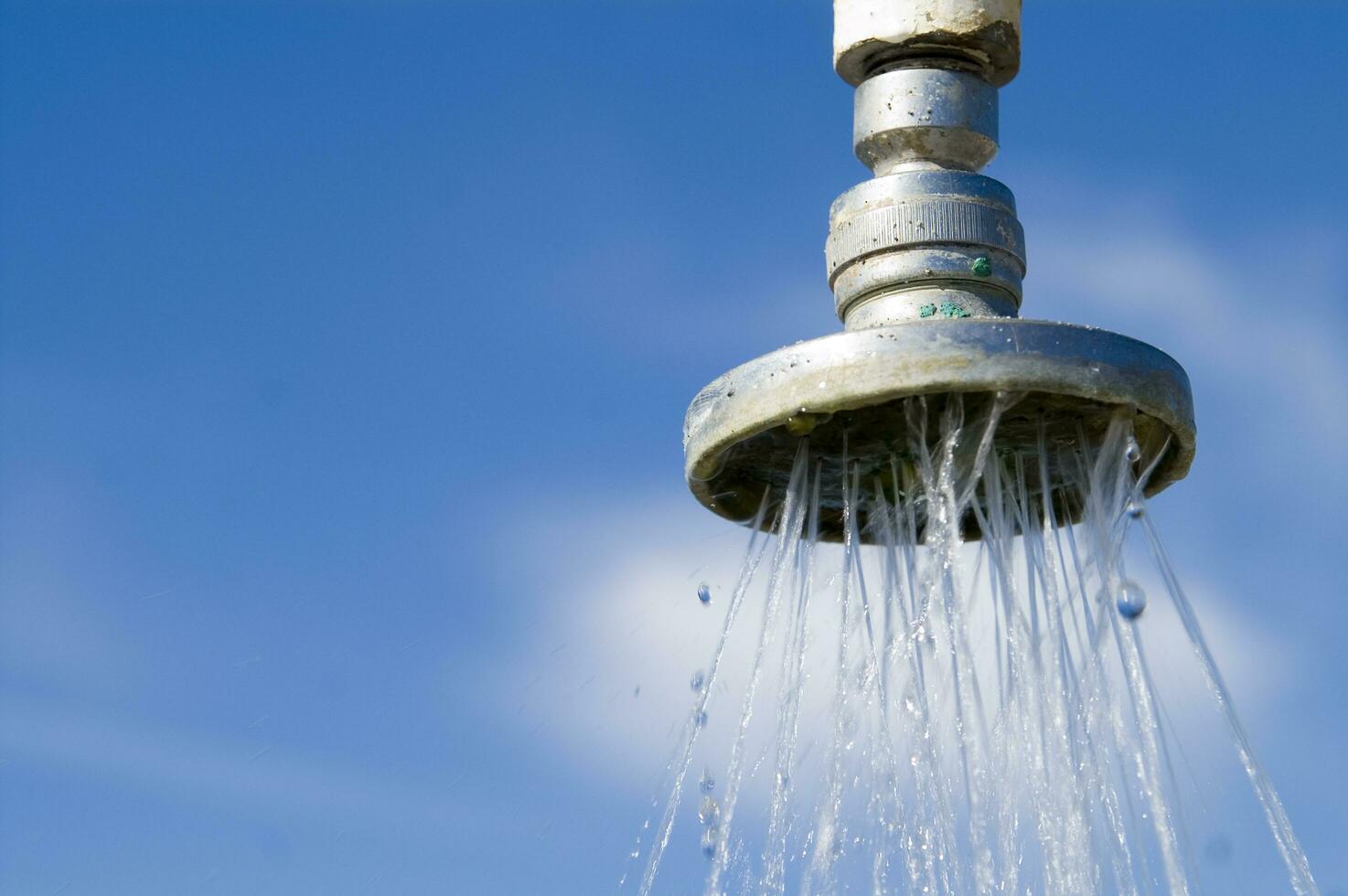 a water pipe with a drop of water on it photo