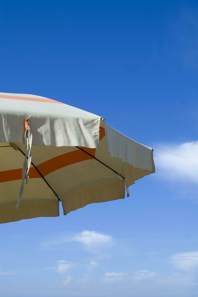 a beach umbrella with a striped cover photo