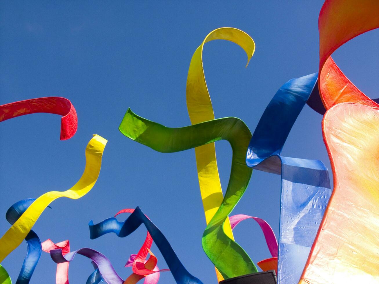 a group of colorful kites flying in the sky photo